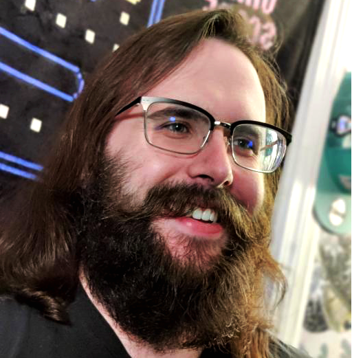 profile pic of John. Long hair, full beard, glasses.